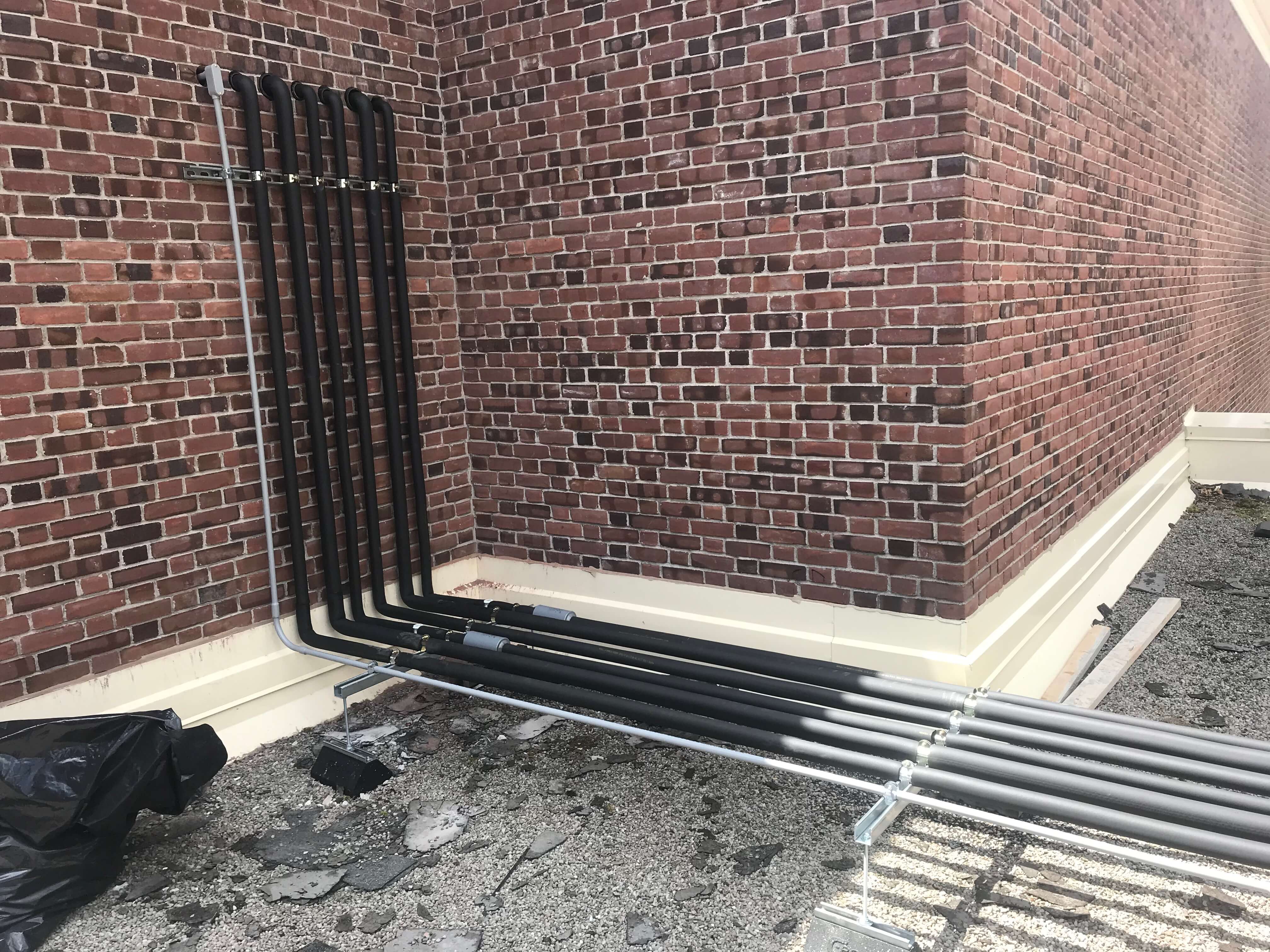 Pipes coming out of brick wall